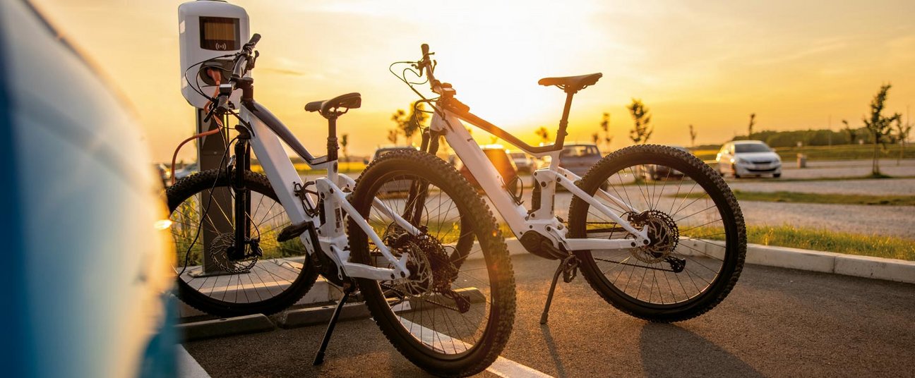 Das Einstiegsbild zeigt zwei Elektrofahrräder im Sonnenaufgang.
